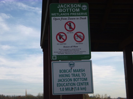 Sign – “Jackson Bottom Wetlands Preserve – open dawn to dusk – Bobcat Marsh Hiking Trail to education center – 1 mile”